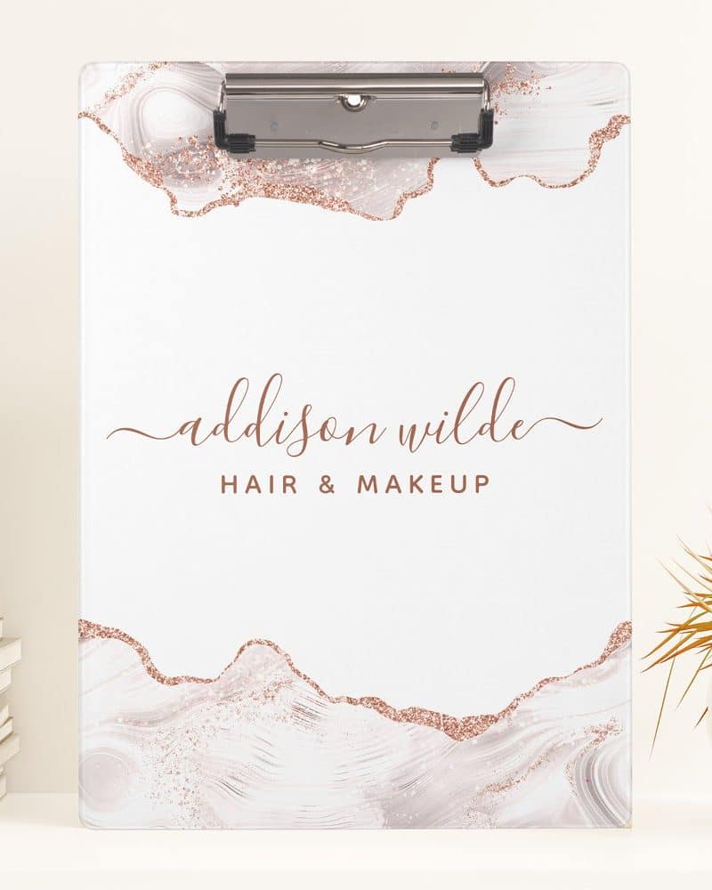 Rose gold clipboard with marble design and Addison Wilde Hair & Makeup logo.