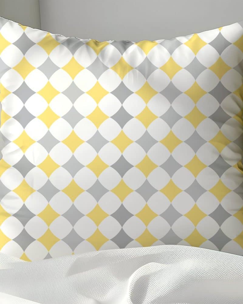 Yellow and gray geometric patterned throw pillow.