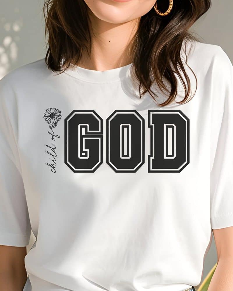 White t-shirt with large black GOD lettering and small Child of God text with daisy graphic.