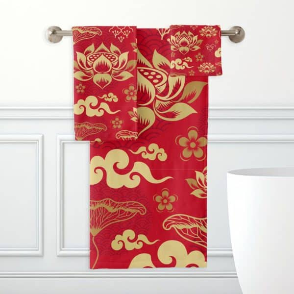 Red Bath Towels With A Gold Lotus Flower And Cloud Pattern Hanging On A Towel Rack.