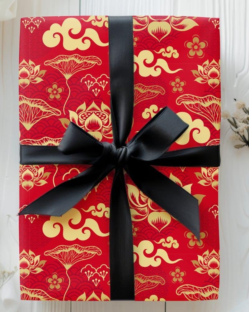 Red gift box with gold Asian-inspired pattern and black ribbon.