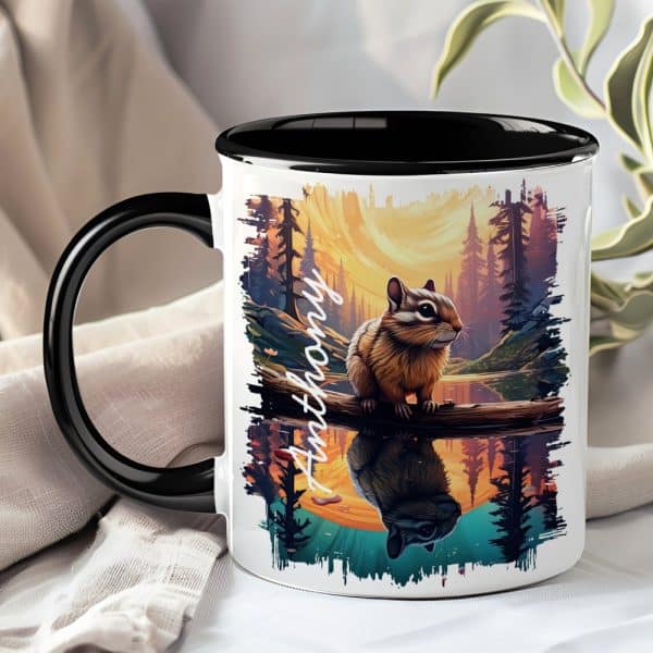 A Coffee Mug With A Black Handle And Interior Features A Personalized Name, Anthony, And An Illustration Of A Chipmunk Sitting On A Branch Over A Reflective Body Of Water At Sunset.
