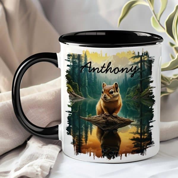A Black-Handled Mug With A Personalized Name, Anthony, And A Painting Of A Chipmunk Sitting On A Log Over A Lake In A Forest.