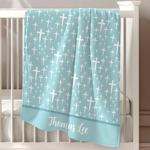 Light Blue Baby Blanket With A White Cross Pattern And The Name Thomas Lee.