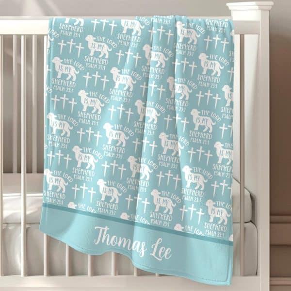 Light Blue Baby Blanket With A Repeating Pattern Of Lambs, Crosses, And The Text &Quot;The Lord Is My Shepherd, Psalm 23:1,&Quot; Personalized With The Name Thomas Lee.