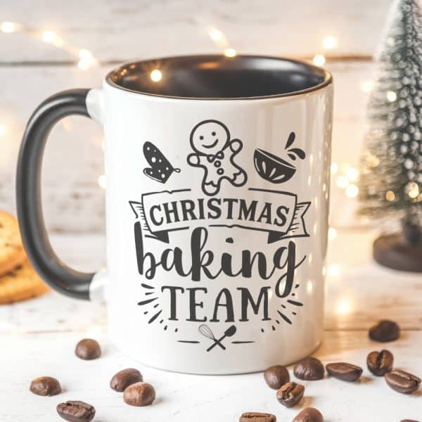 White Coffee Mug With Black Text And Illustrations; Text Reads Christmas Baking Team.