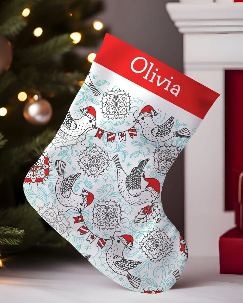 Personalized Christmas stocking with a teal and white bird design, and the name Olivia.