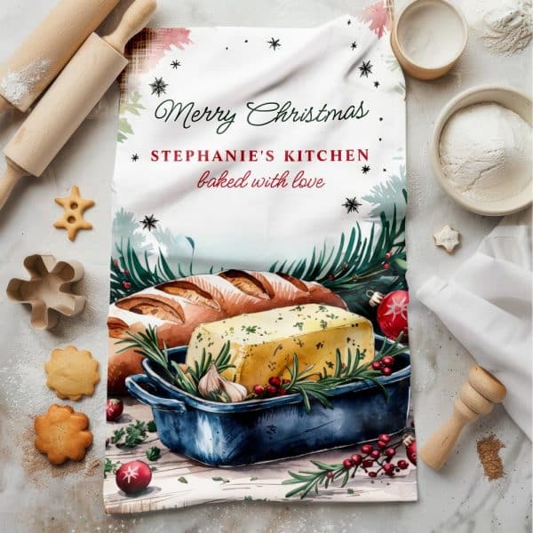 A Christmas-Themed Kitchen Towel Featuring A Watercolor Illustration Of Bread And A Dish Of Herb Butter, With The Text Merry Christmas, Stephanie'S Kitchen, Baked With Love.