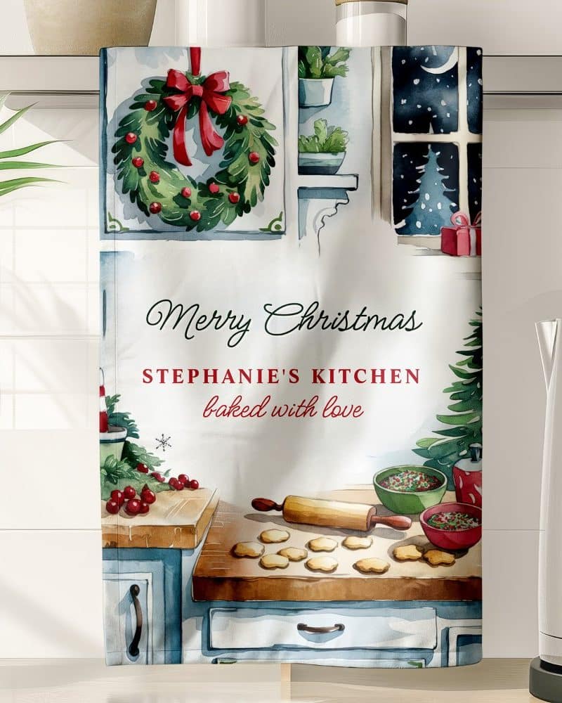 Christmas kitchen towel with watercolor illustration of cookies and baking supplies, personalized with a name and Merry Christmas message.
