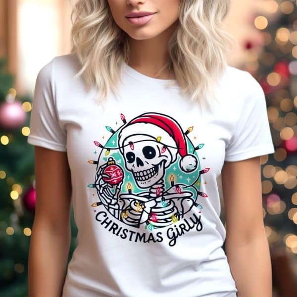 White T-Shirt Featuring A Skeleton Wearing A Santa Hat And Holding An Ornament, Surrounded By Christmas Lights.
