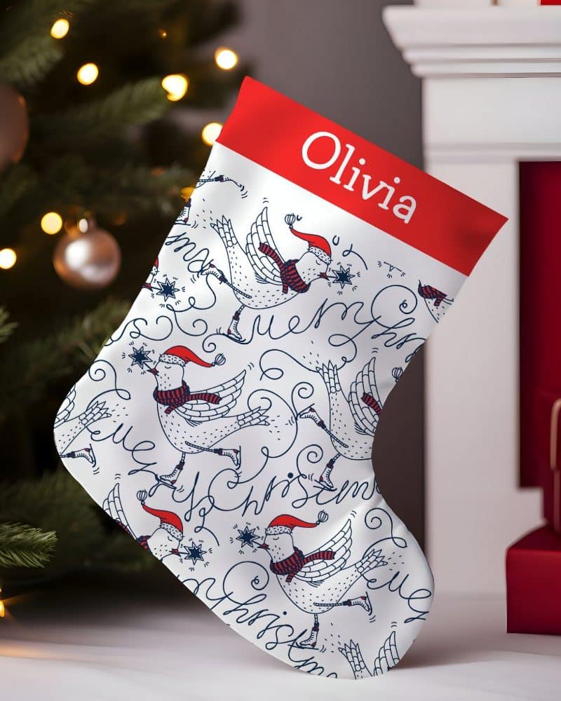 Personalized Christmas stocking with a pattern of birds ice skating and the name Olivia.