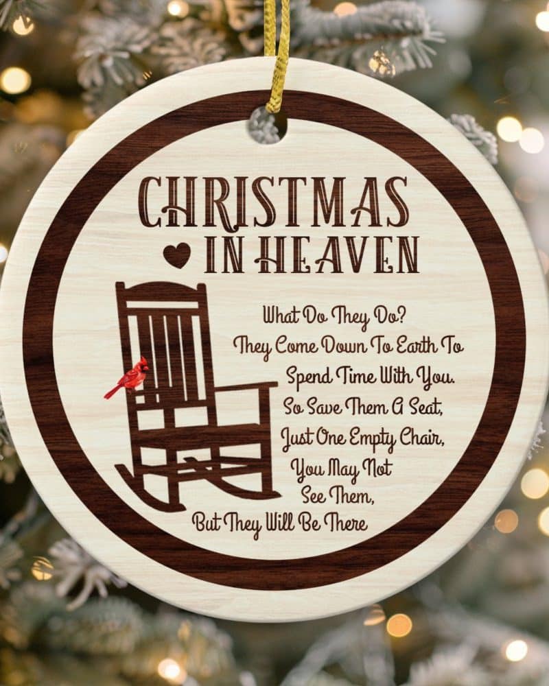 Round Christmas ornament with a rocking chair, cardinal, and text that reads Christmas in Heaven. The text describes loved ones spending Christmas in heaven.