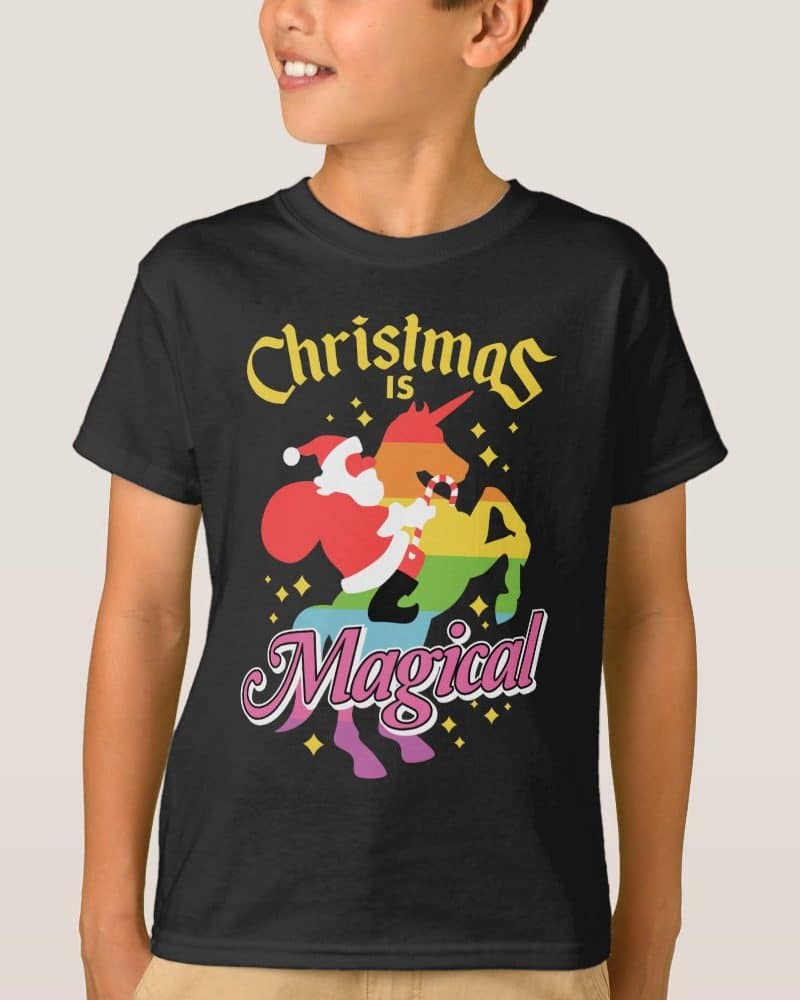 Black t-shirt featuring a rainbow unicorn with Santa Claus riding it. Text reads Christmas is Magical.