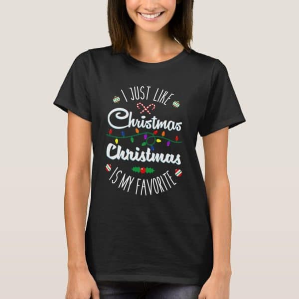 Woman Wearing A Black T-Shirt With A Christmas Design That Says I Just Like Christmas Christmas Is My Favorite.
