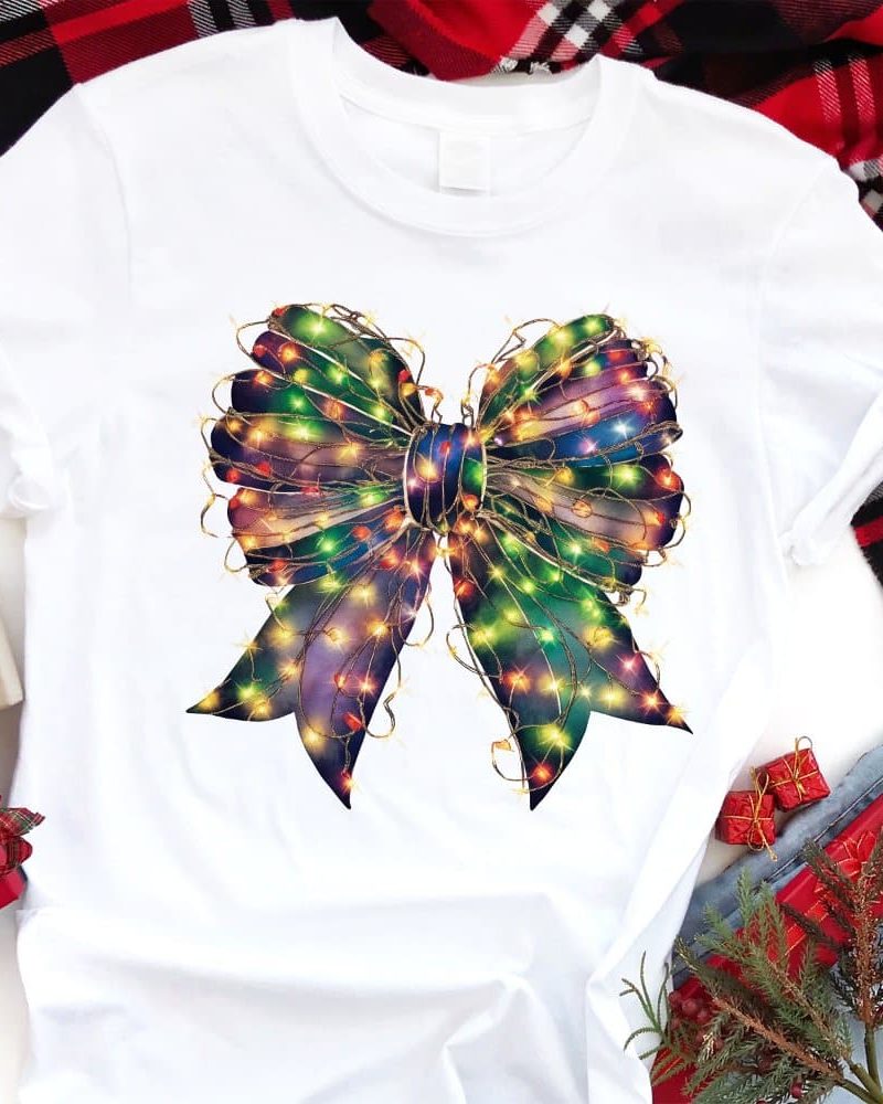 White t-shirt featuring a colorful bow adorned with twinkling lights.
