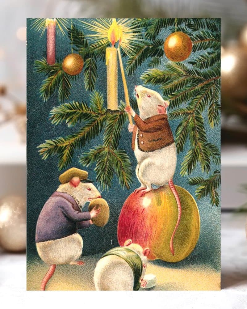 Three mice decorating a Christmas tree; one mouse sits atop a large apple, another holds an ornament, and a third sits nearby.