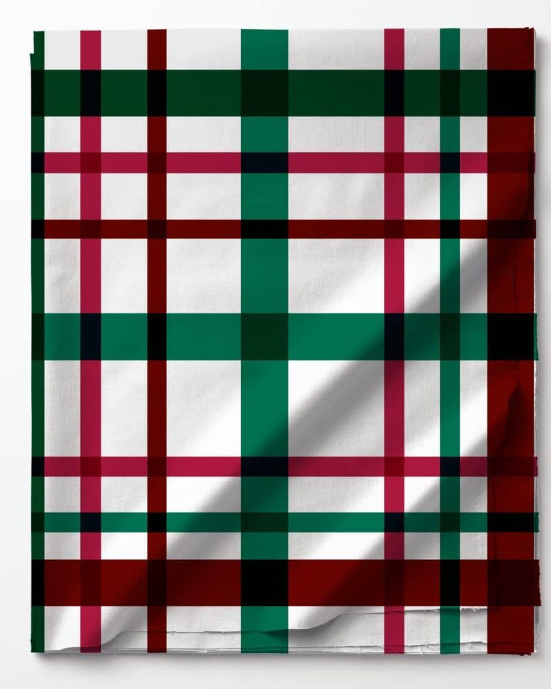 White fabric with a green, red, and black plaid pattern.