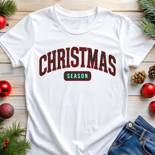 White T-Shirt With Red And Green Christmas Themed Text That Says Christmas Season.