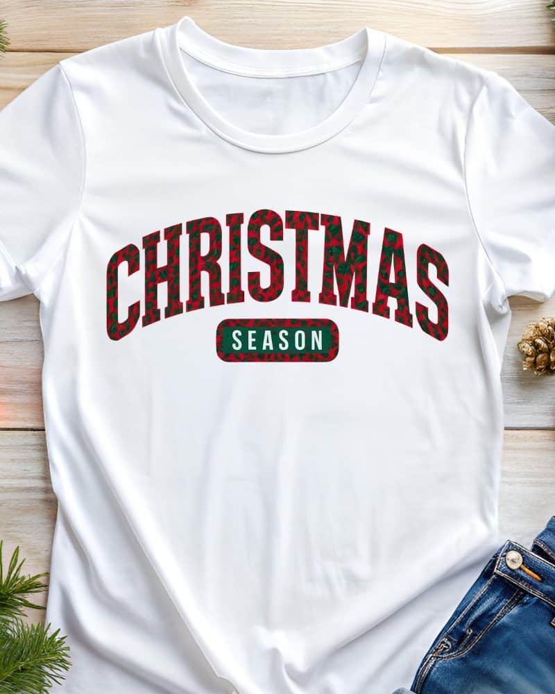 White t-shirt with red and green Christmas themed text that says Christmas Season.