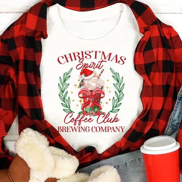 White T-Shirt With Christmas Coffee Club Brewing Company Logo Featuring A Festive Coffee Drink.