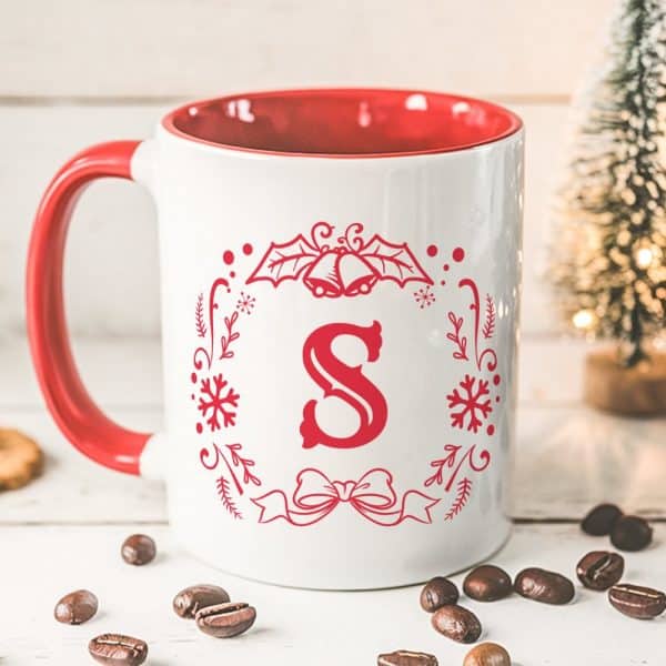 Red-Handled Mug With A White Christmas Design Featuring The Letter S.