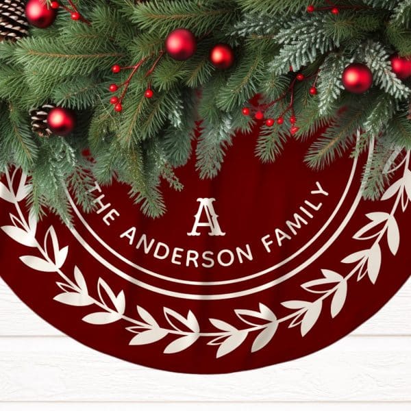 Red Christmas Tree Skirt With The Anderson Family Name And Initial A In A Cream-Colored Circular Design. Pine Boughs And Ornaments Adorn The Top.
