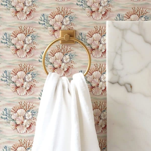 White Towel Hanging On A Gold Ring Against A Seashell Patterned Wallpaper.