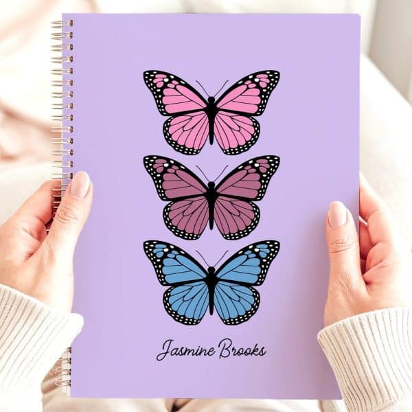 Purple Spiral Notebook With Three Butterflies In Pink, Mauve, And Blue, Personalized With The Name Jasmine Brooks.