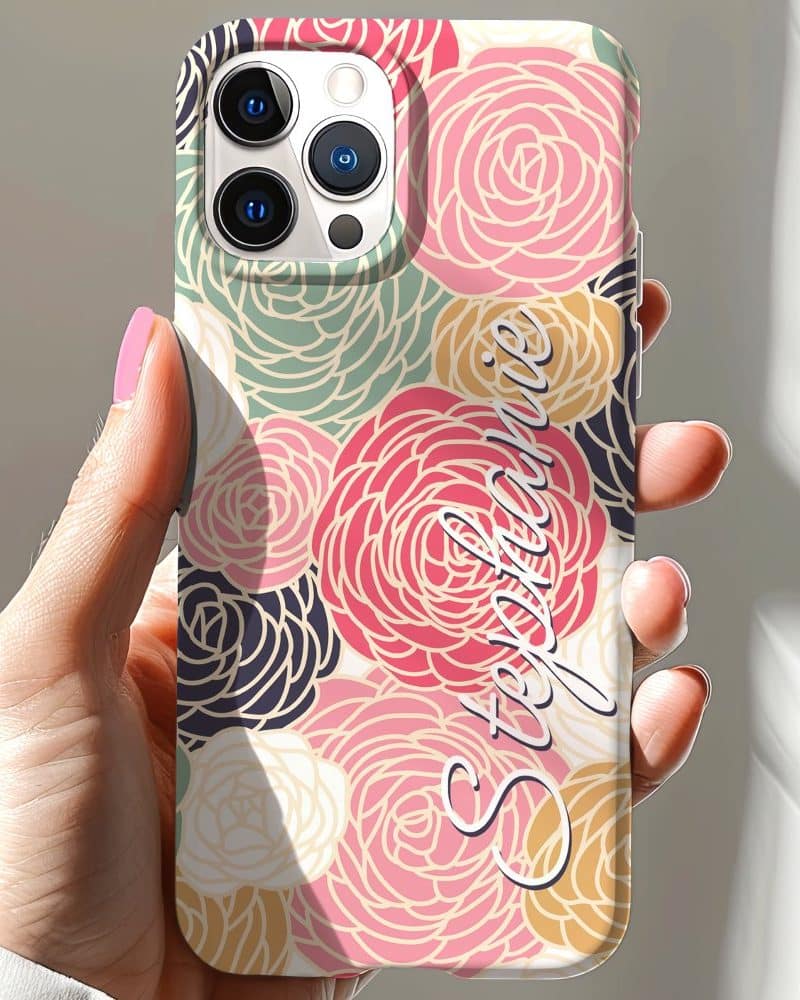 A hand holds a phone case featuring a floral design and the name Stephanie.