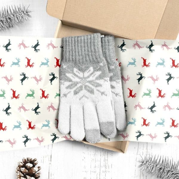 Grey And White Snowflake Patterned Gloves In A Gift Box Lined With Reindeer Patterned Paper.