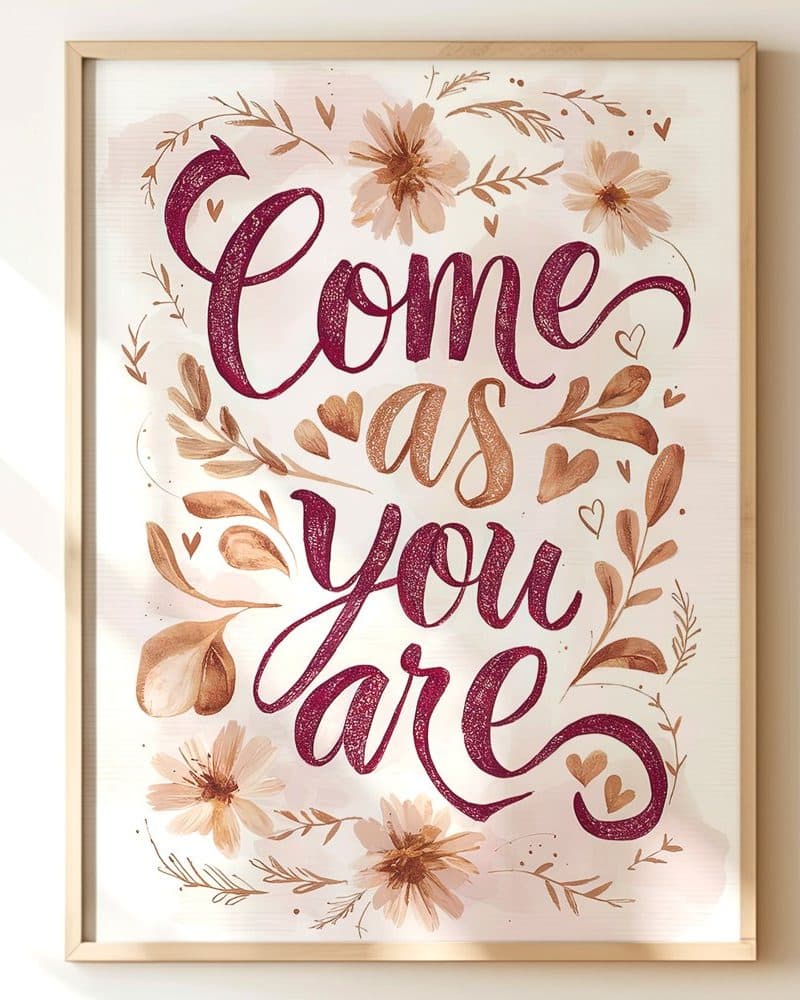 Framed watercolor print with the text Come as you are in burgundy script surrounded by tan flowers and leaves.