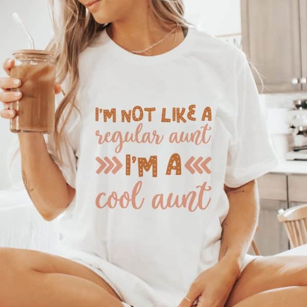 Woman Wearing A White T-Shirt That Says Im Not Like A Regular Aunt Im A Cool Aunt.