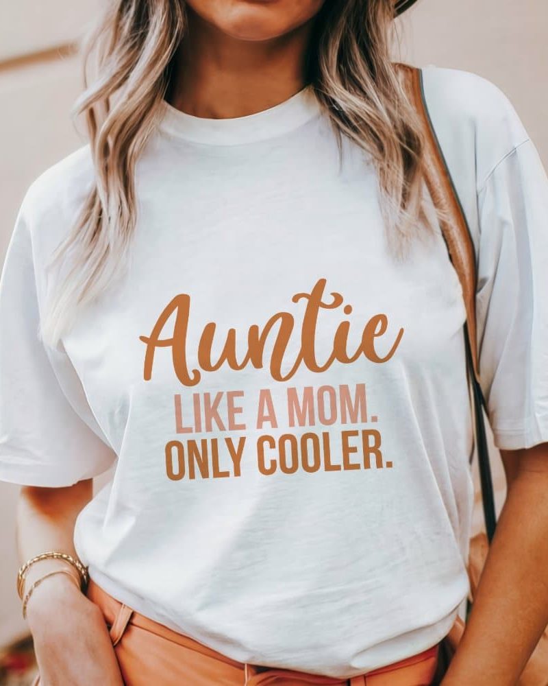 Woman wearing a white t-shirt that says Auntie Like a Mom. Only Cooler.