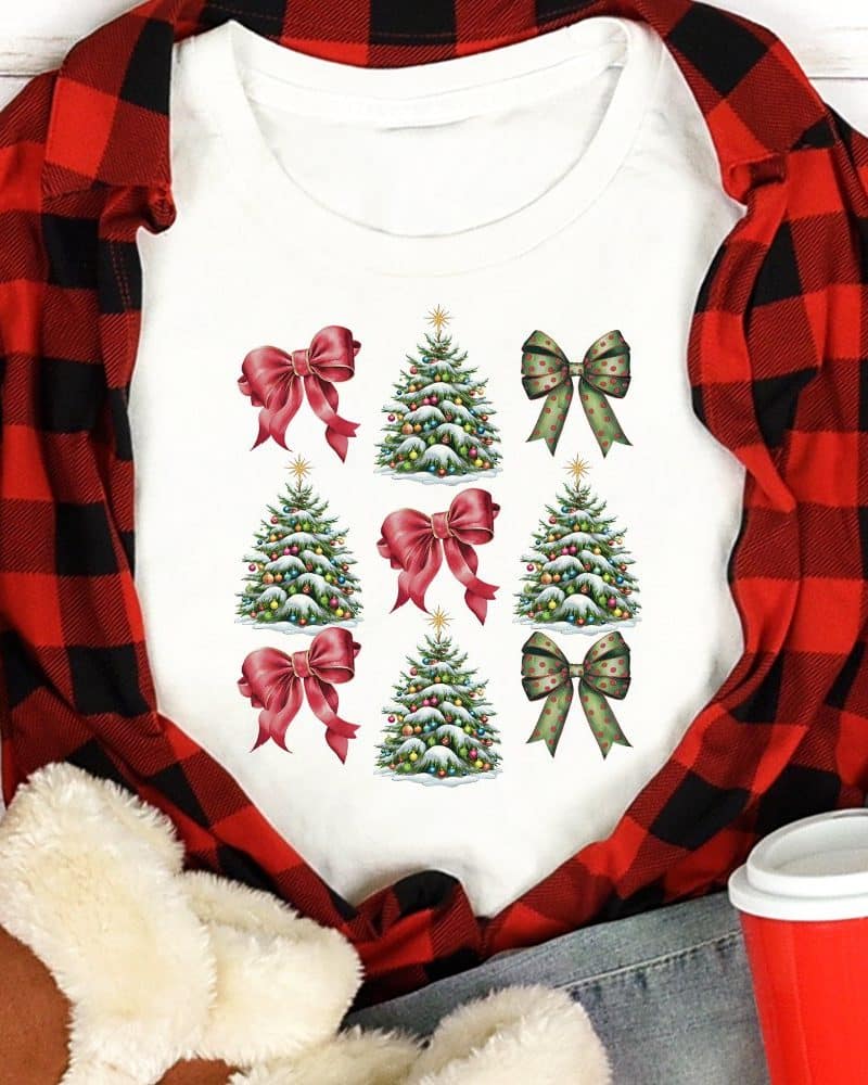 White shirt with a repeating pattern of Christmas trees and bows.