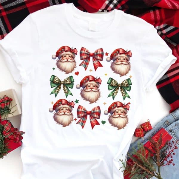 White T-Shirt With A Repeating Pattern Of Santa Claus Faces And Bows.