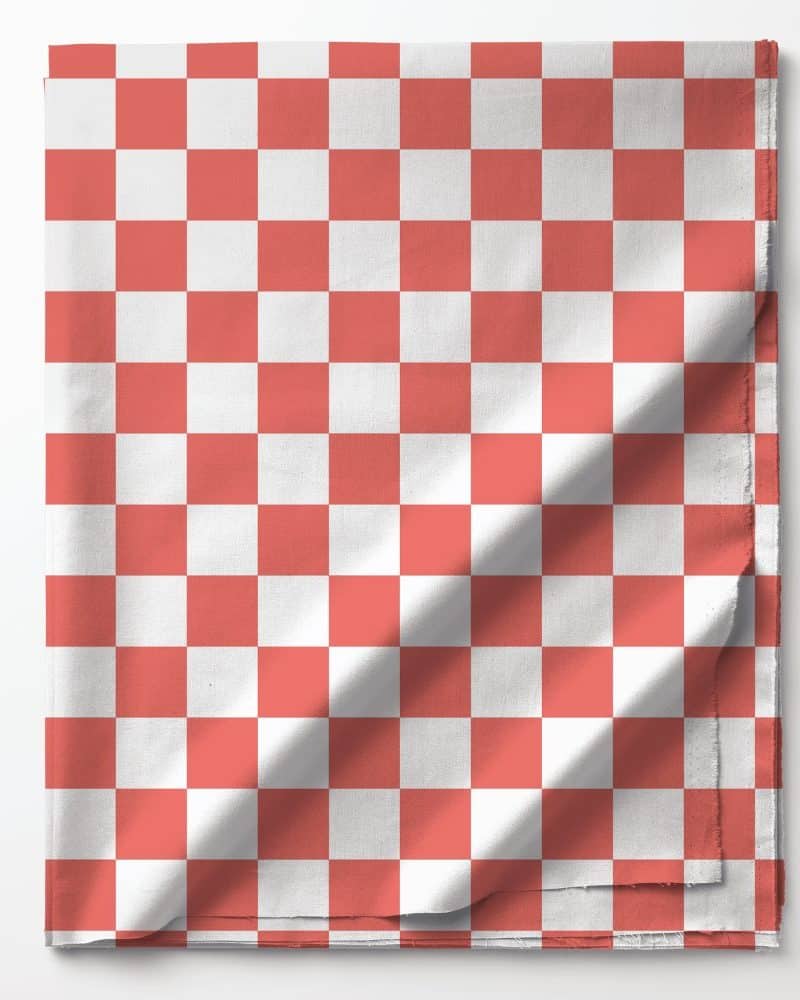 Coral and white checkered fabric folded on a white background.