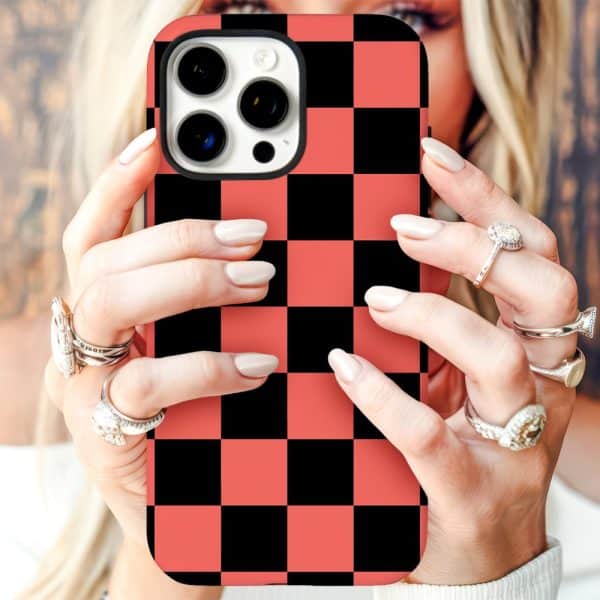 Woman'S Hands Holding A Coral And Black Checkered Phone Case.