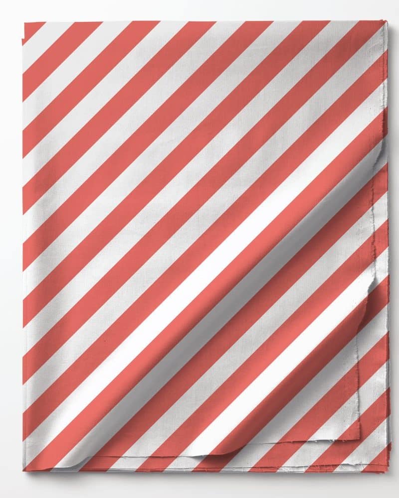 Coral and white diagonal striped fabric folded on a white background.