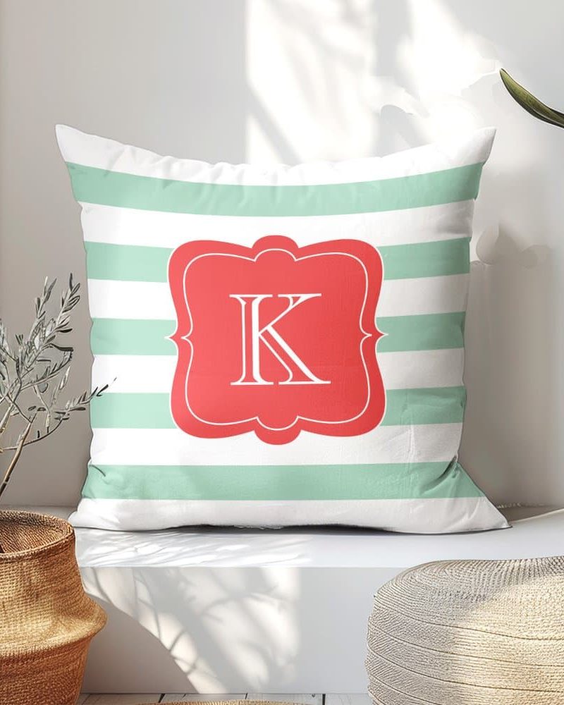 Mint green striped pillow with a coral monogrammed K.