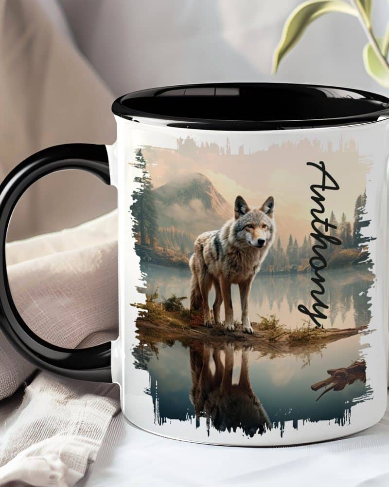 Black-handled mug with a wolf reflected in a calm lake, mountains in the background, and the name Anthony.