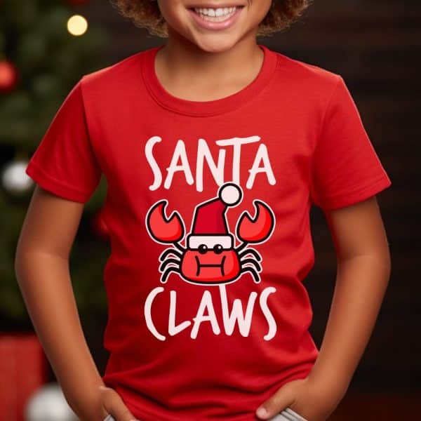 Child Wearing A Red T-Shirt With A Design That Says Santa Claws And Features A Cartoon Crab Wearing A Santa Hat.