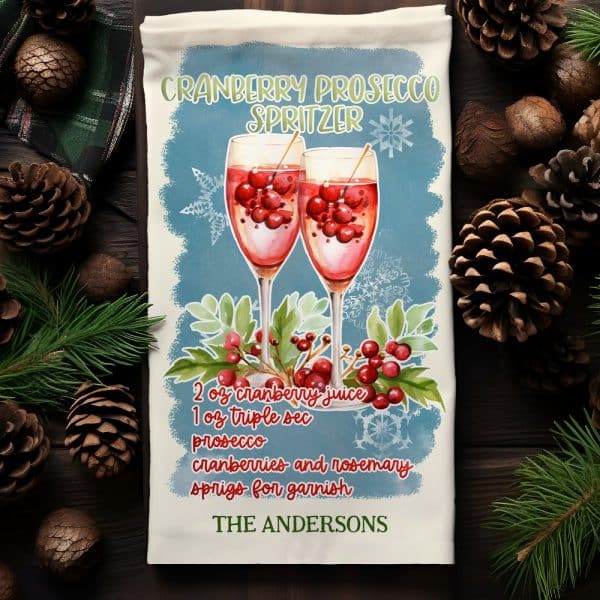 Personalized Kitchen Towel Featuring A Watercolor Illustration Of Two Glasses Of Cranberry Prosecco Spritzer, With Recipe And Name.