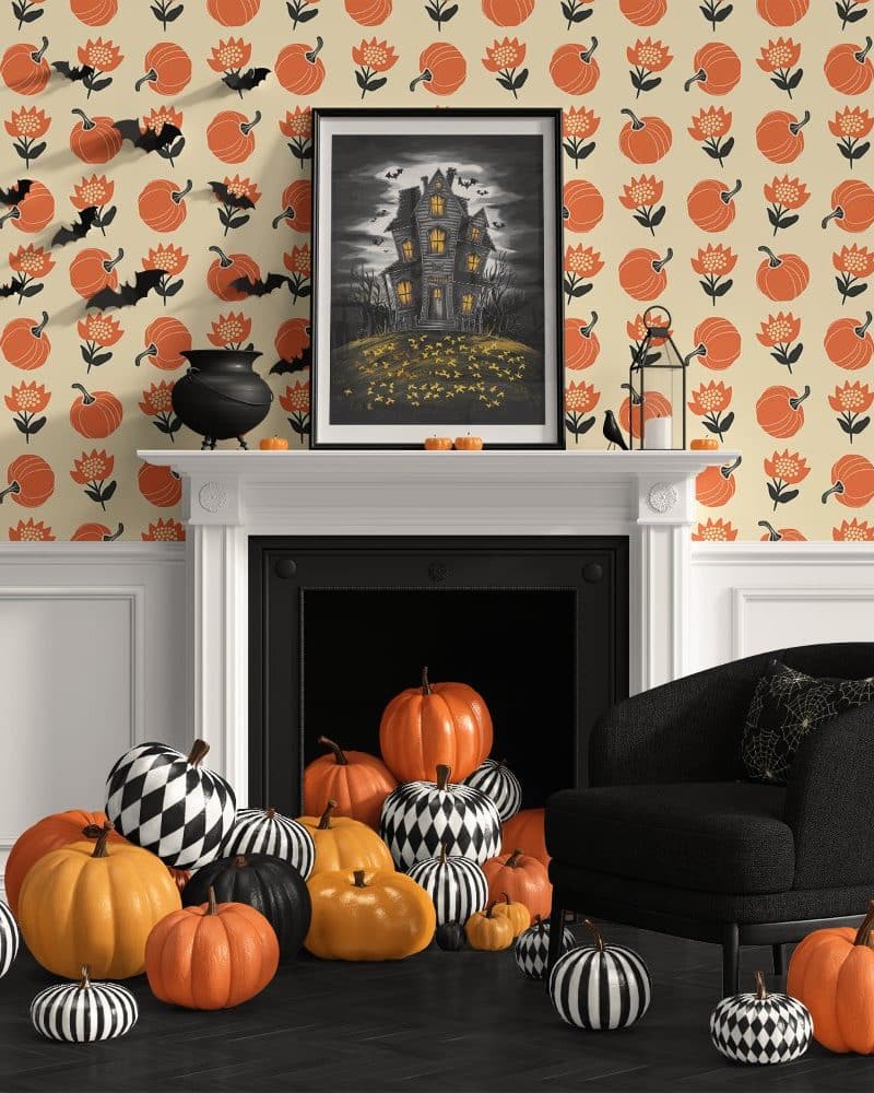 A pile of orange and black and white pumpkins sits in front of a fireplace with a Halloween-themed illustration above it.