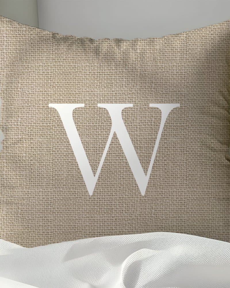 Beige burlap pillow with a white capital W.