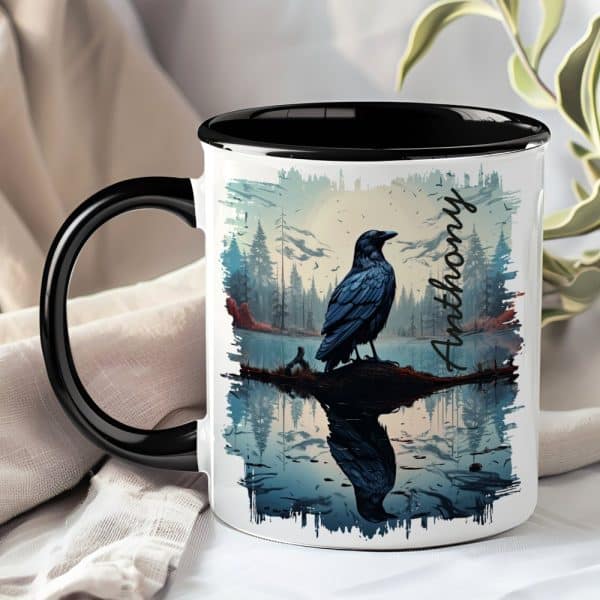 A Black Mug With A Black Handle Features A Raven Perched On A Branch Over Water, Reflected In The Still Surface. The Name Anthony Is Printed On The Mug.