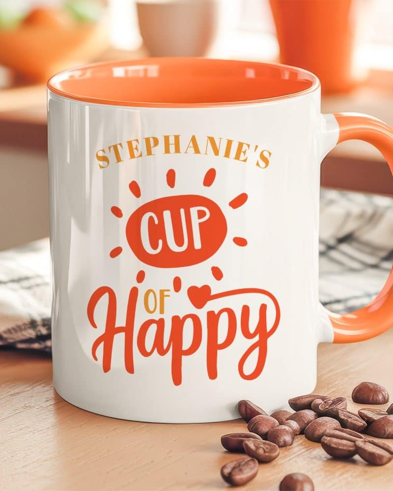 White coffee mug with orange interior and handle, personalized with Stephanies Cup of Happy design.