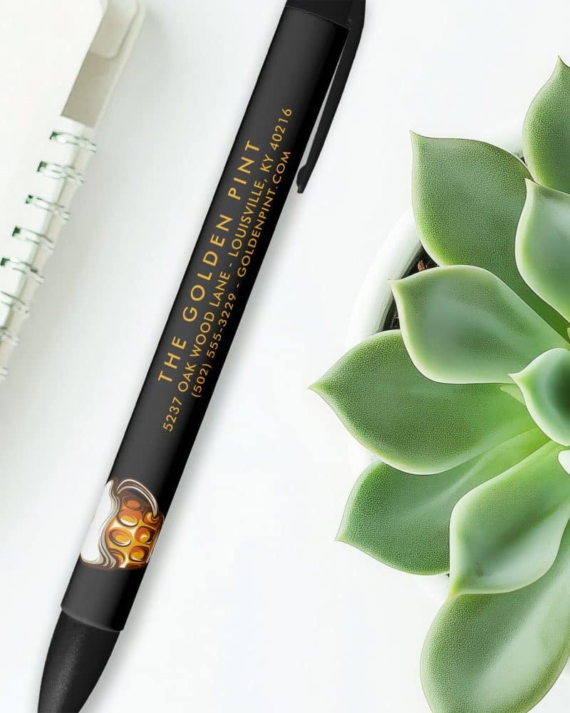 Black pen with gold lettering advertising The Golden Pint, including address and phone number.