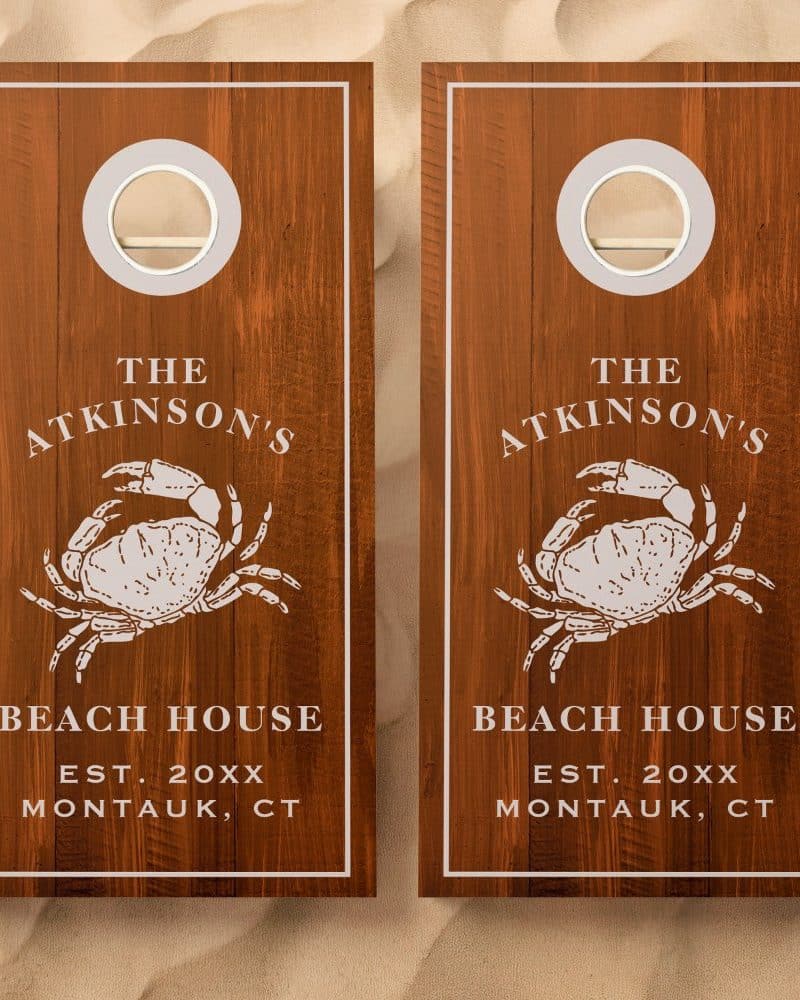 Pair of brown wooden cornhole boards with a crab design, "The Atkinsons Beach House, Montauk, CT" text.
