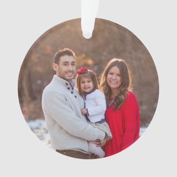 Family Christmas Ornament Featuring A Smiling Family Of Three: A Father, Mother, And Their Young Daughter.