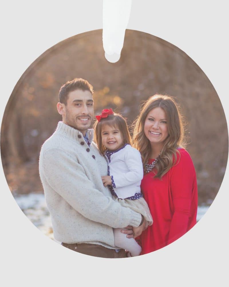 Family Christmas ornament featuring a smiling family of three: a father, mother, and their young daughter.